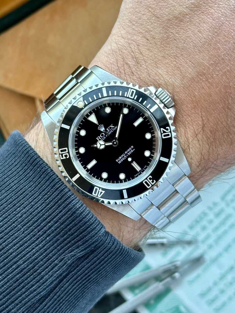 Wrist shot image for Rolex Submariner 14060 Black 1993 with original box and papers