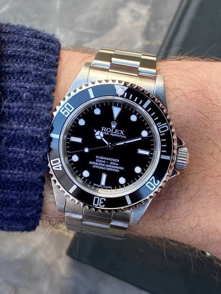 Wrist shot image for Rolex Submariner "engraved rehaut" 14060M Black 2009 with original box and papers