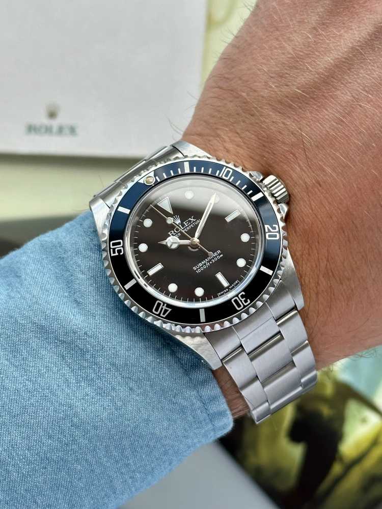 Wrist image for Rolex Submariner 14060M Black 2005 with original box and papers