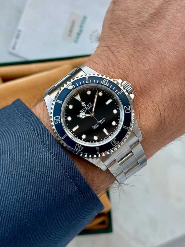 Wrist shot image for Rolex Submariner 14060 Black 1995 with original box and papers