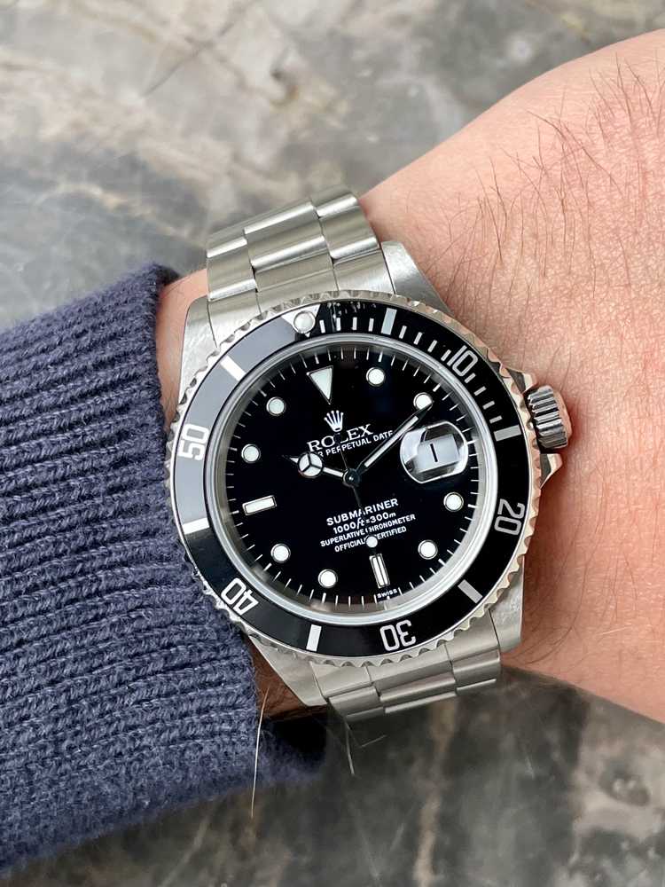 Wrist shot image for Rolex Submariner "Swiss" 16610 Black 1997 with original box and papers