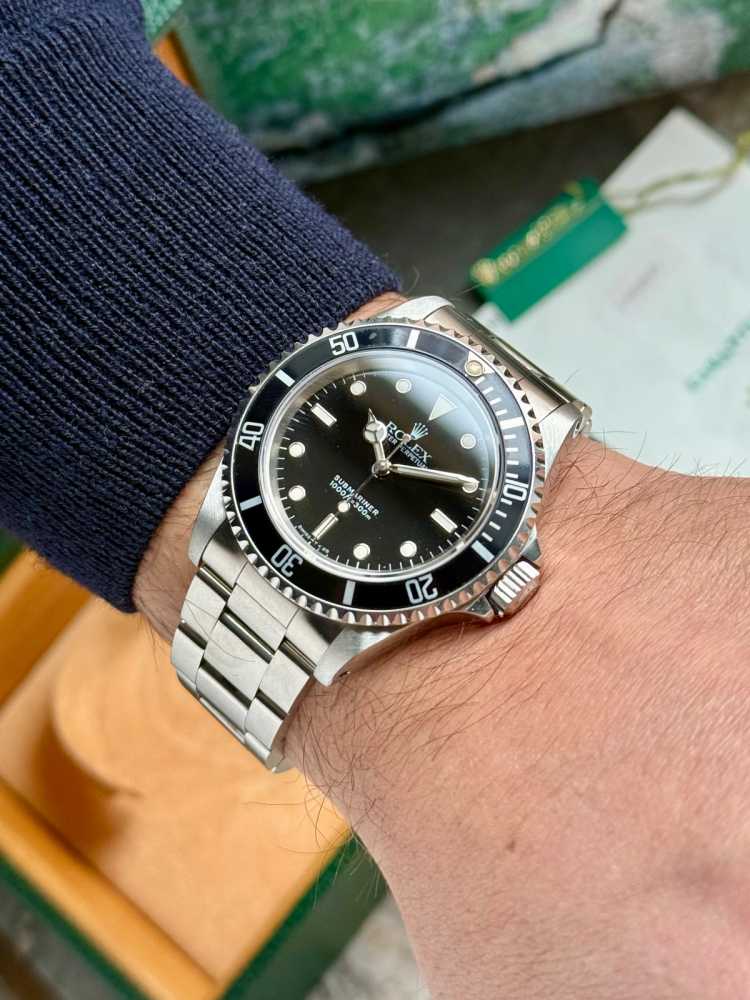 Wrist shot image for Rolex Submariner 14060 Black 1995 with original box and papers 2