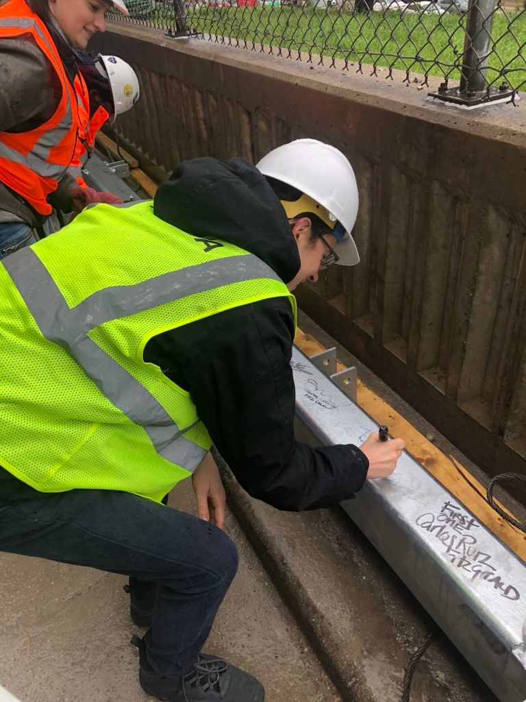 Martin White SE, senior engineer at TGRWA, signing the commemorative steel beam at the topping-off ceremony