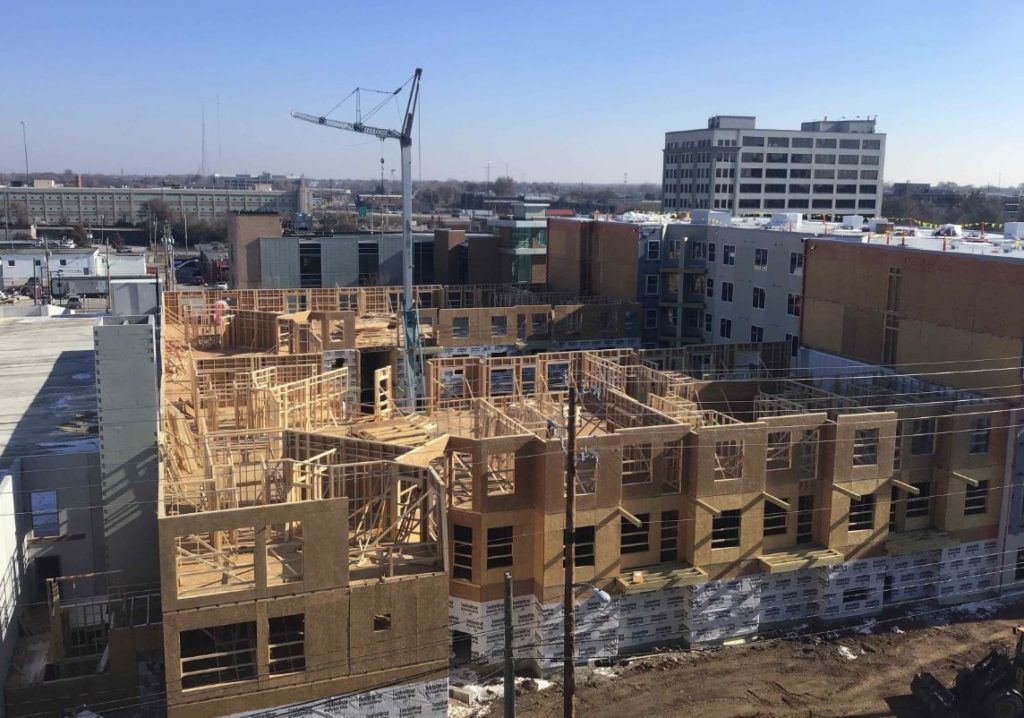 While the the wood-frame structure in construction, one of the fire walls at an expansion joint can be identified (right-hand side)