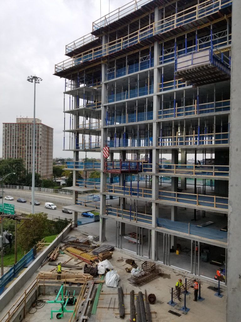 A progress photo taken in October, 2019. Features visible in this photo include: the third floor pool deck and pool, the cantilevered balcony slabs, and the angled overall shape of the building.