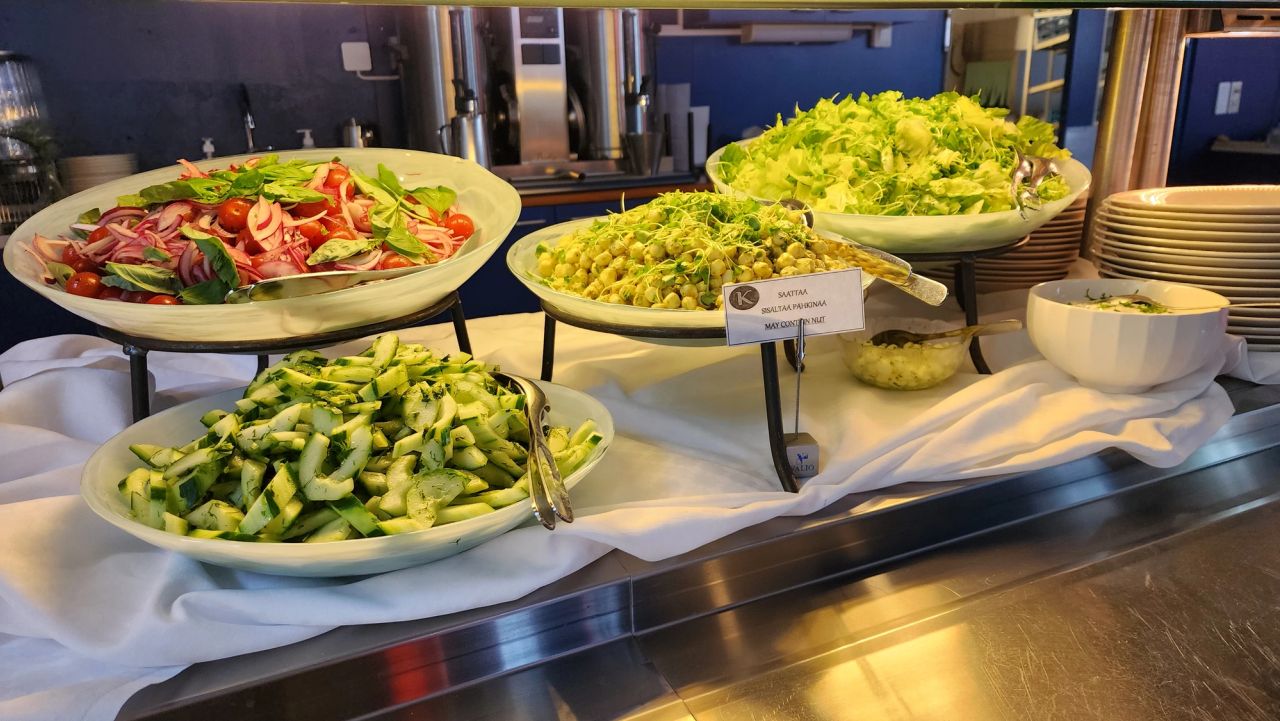 Fresh salad spread with tomato, cucumber, peas and greens