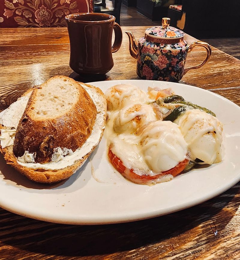 Eggs benedict with fresh teapot on the side