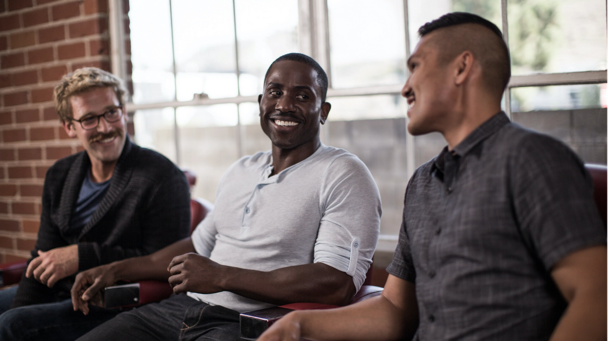 3 men sitting side by side