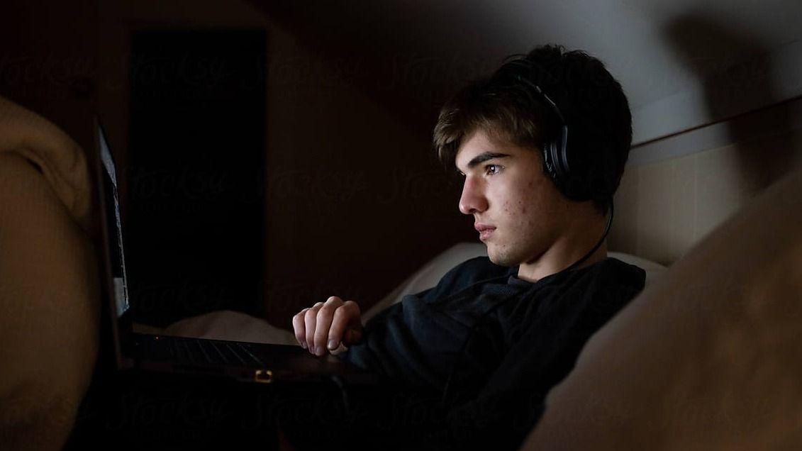 Young man starring into their phone