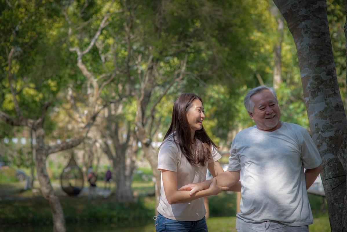 Older man and female partner enjoying time outdoors in a park