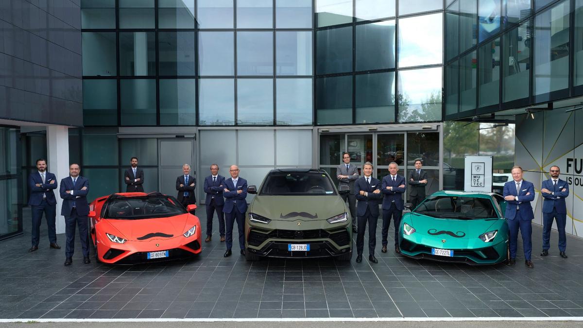 Men standing next to cars