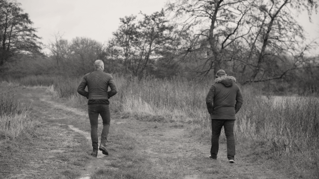 Two men walking outside in nature