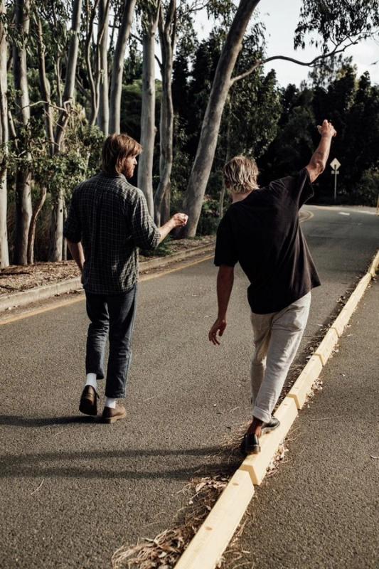 Two young guys walking and talking 