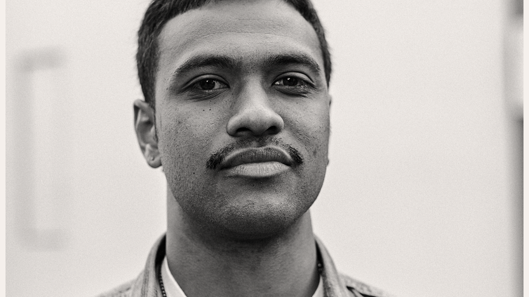 Close up of a young Black man with a moustache