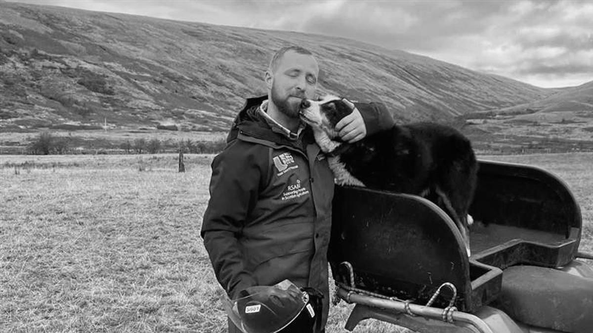 A farmer in the field with his border collie