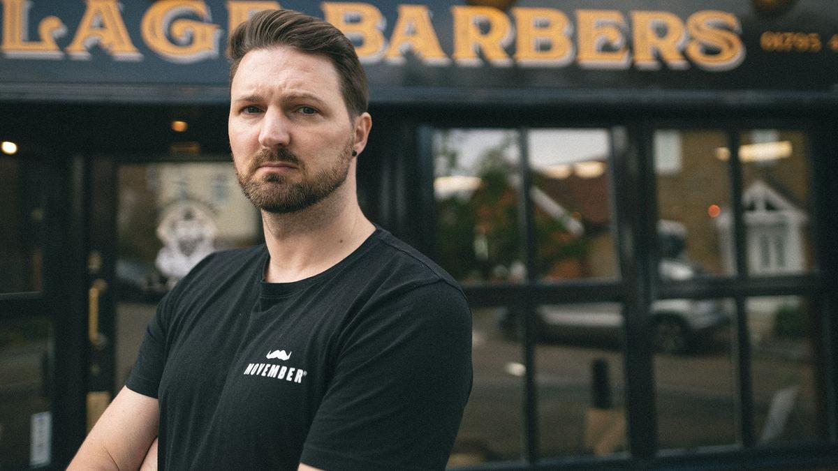 man stood outside barbers