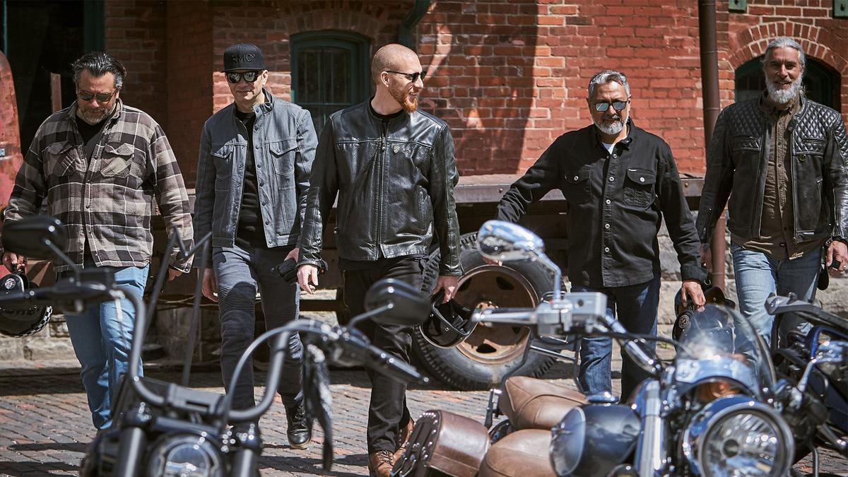 Five guys walk toward their motocycles to go for a ride for men's health.