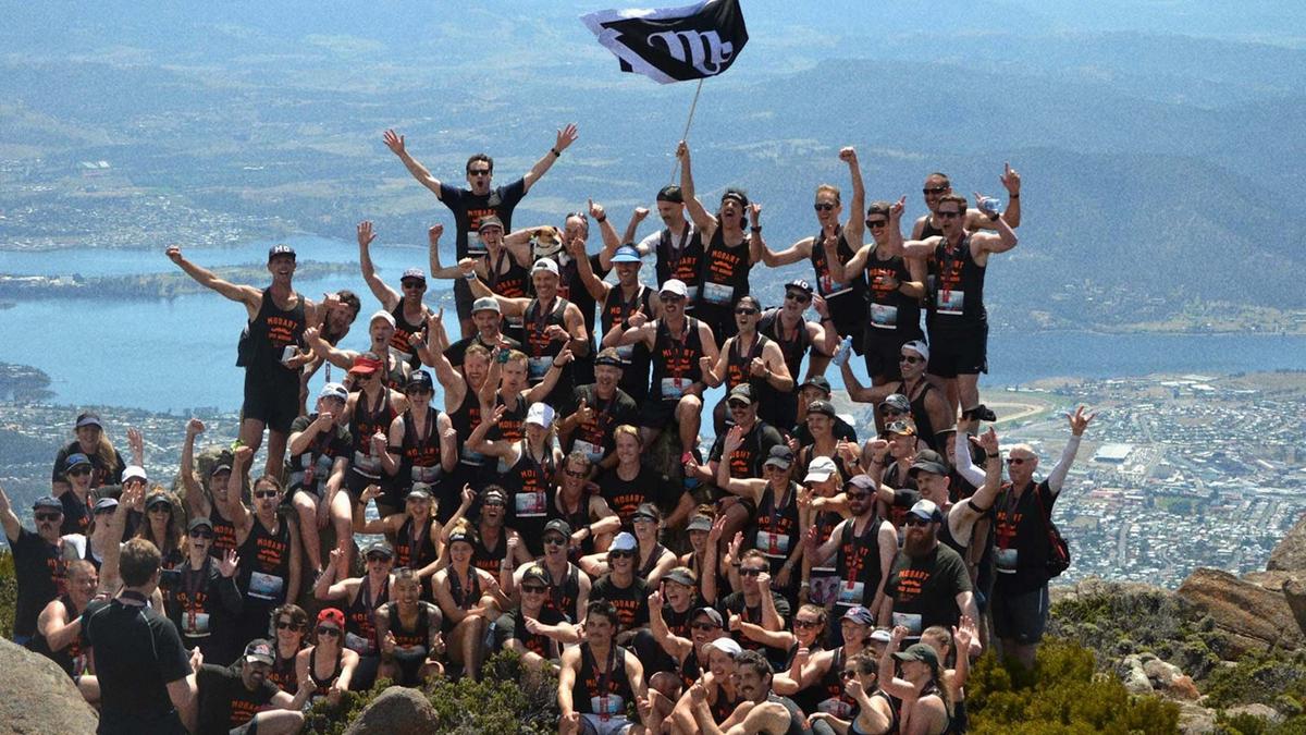 A group of Movember fundraisers celebrating on the mountain top.