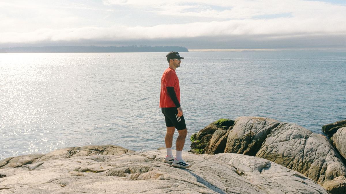 Male runner looks out over the ocean
