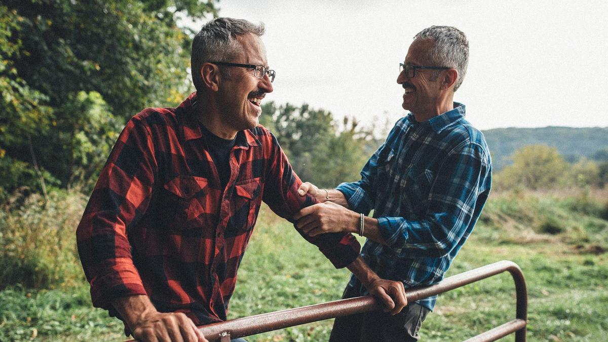 Jon and Mark, two brothers, laughing and embracing
