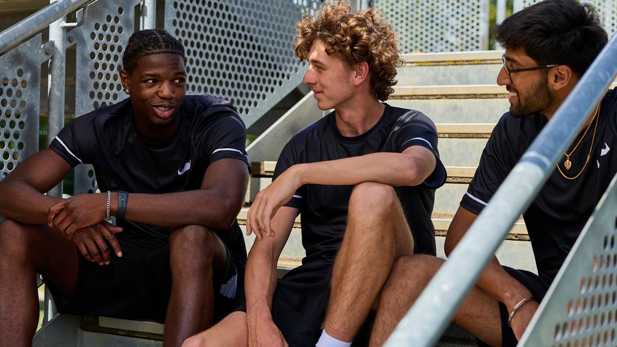 Three young men sat talking