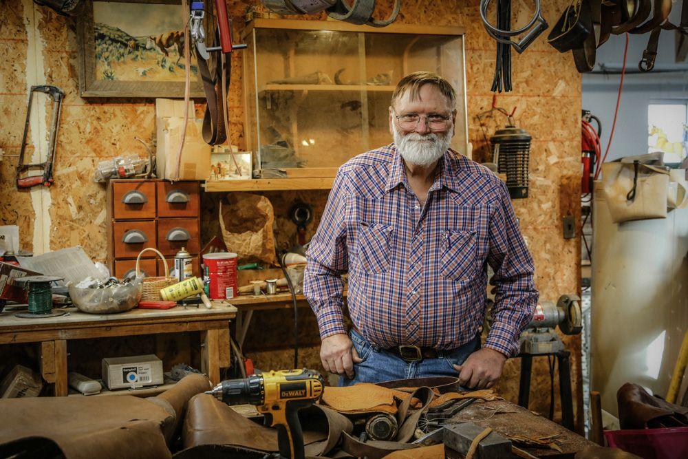 Older man standing in his tool shed