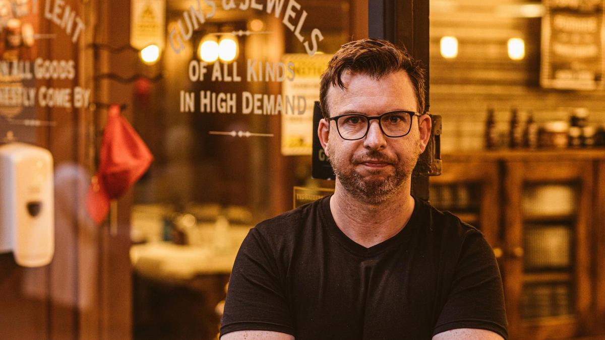 Man stands in front of barber shop