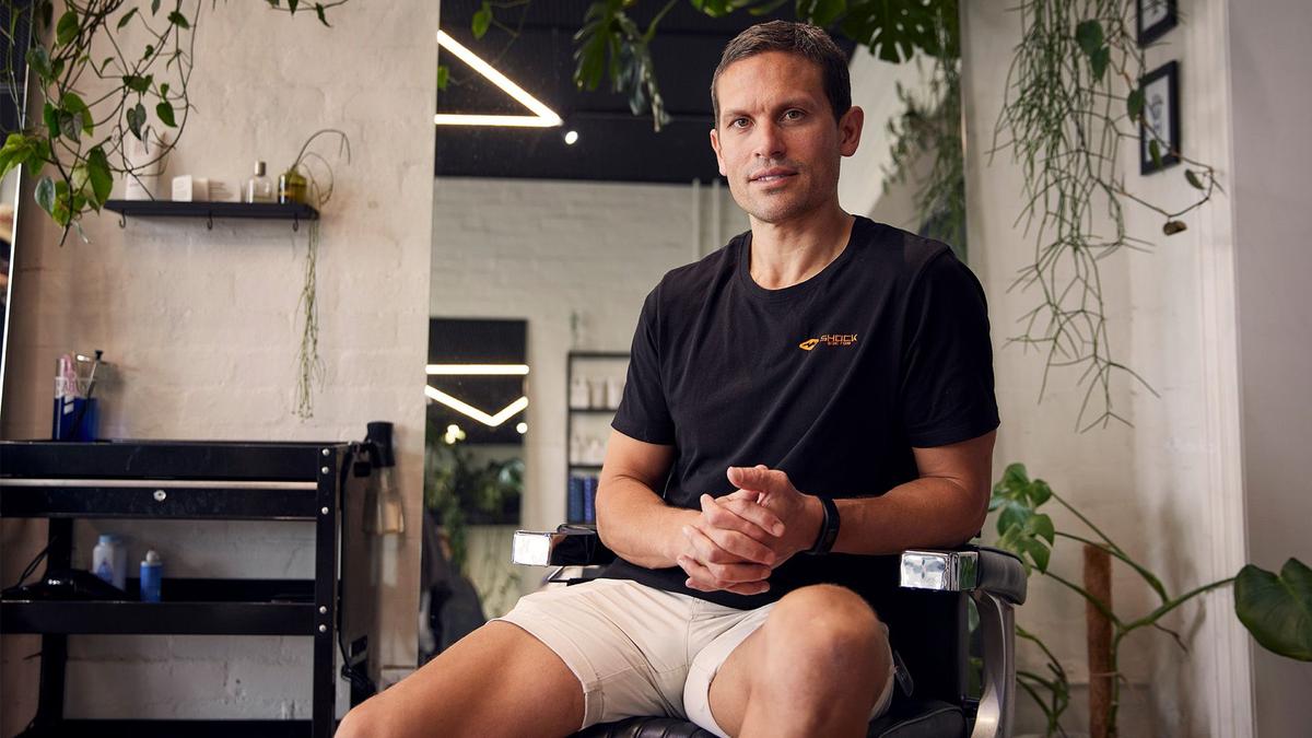 Mo Bro Matt sits in a barber chair