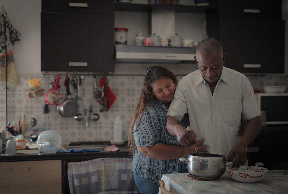 A man and woman preparing a meal together in the kitchen