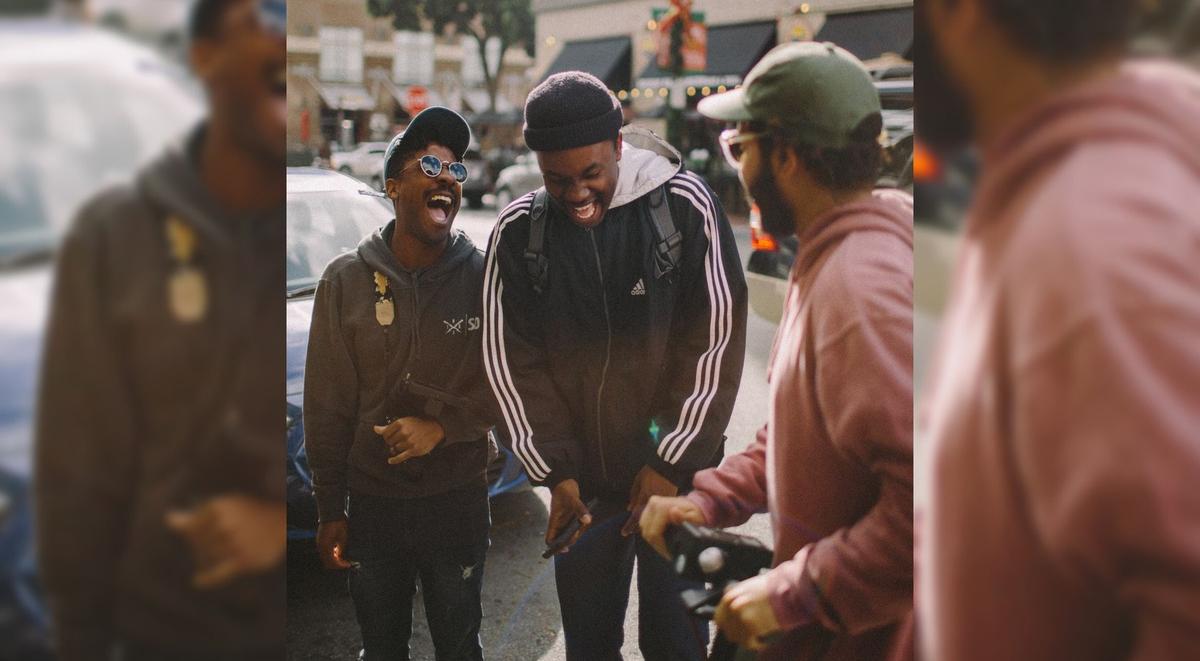 Three friends laughing together.