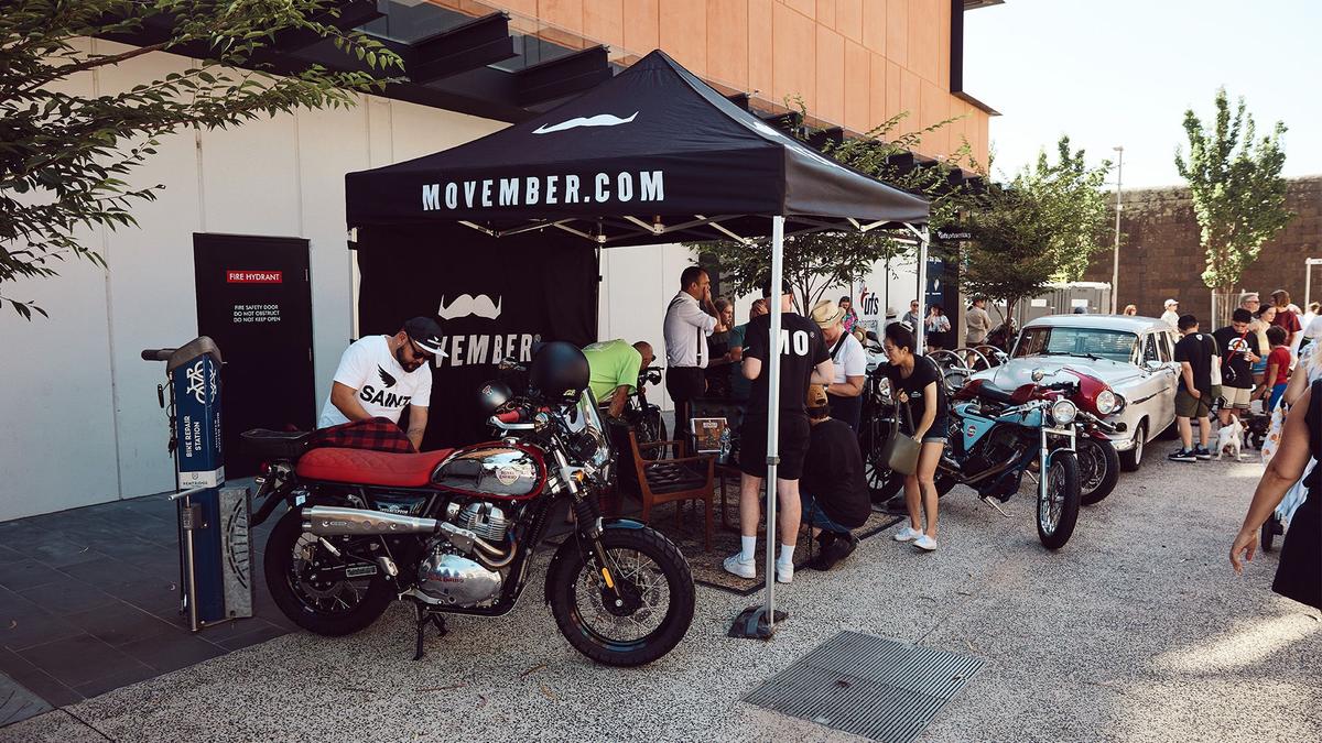 Movember marquee with multiple motorcycles at a market in Melbourne.