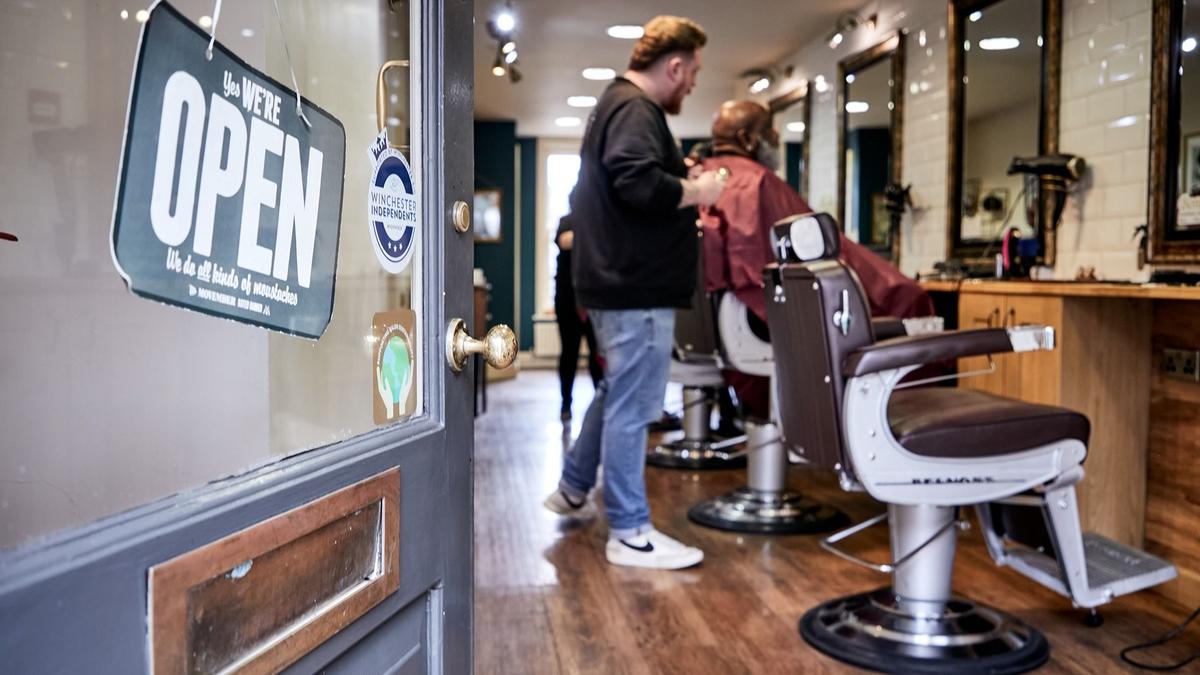 Someone being shaved at the barbers