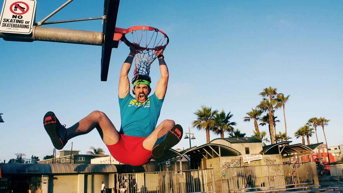 Man doing a slam dunk.