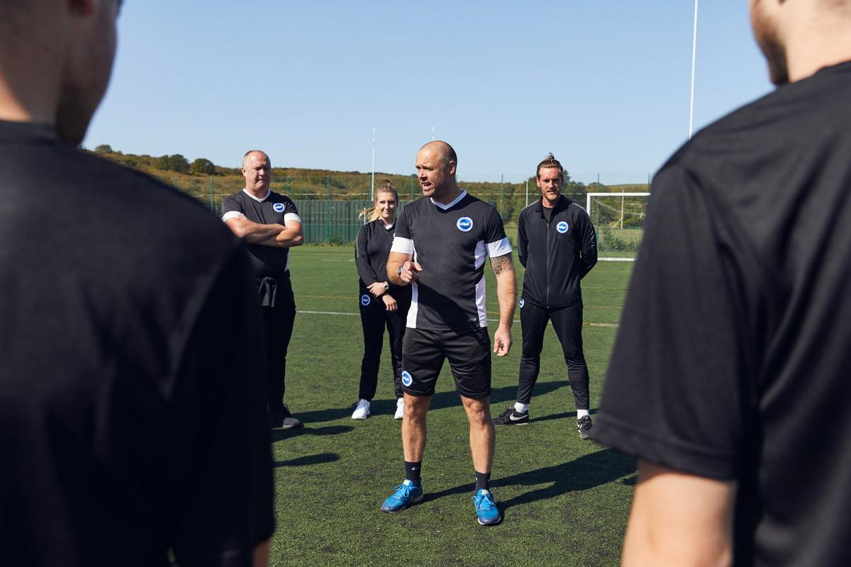 A coach addresses their team during a training session.
