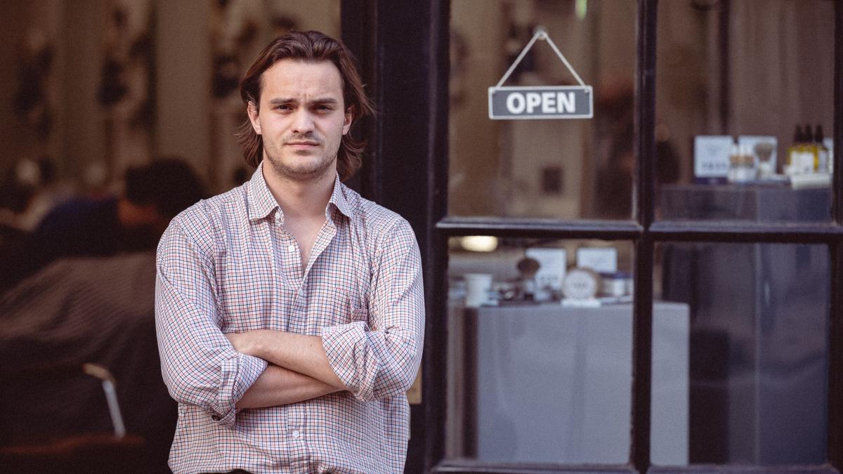 Man stood outside barbershop