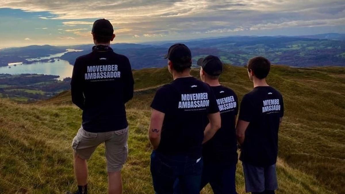 group of men stood looking at a view
