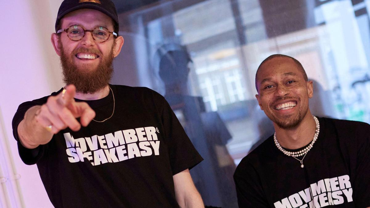 Photo of two young men wearing Movember SpeakEasy t-shirts.