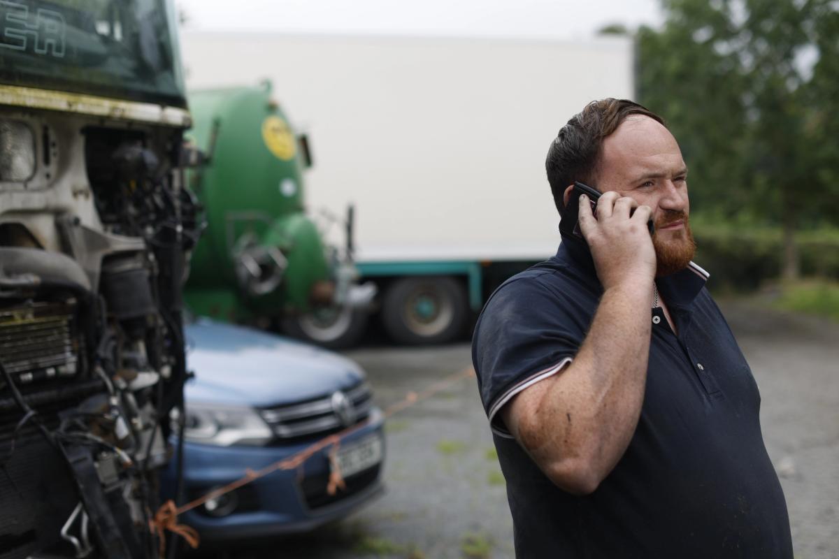 A man looks off to the distance while talking on the phone