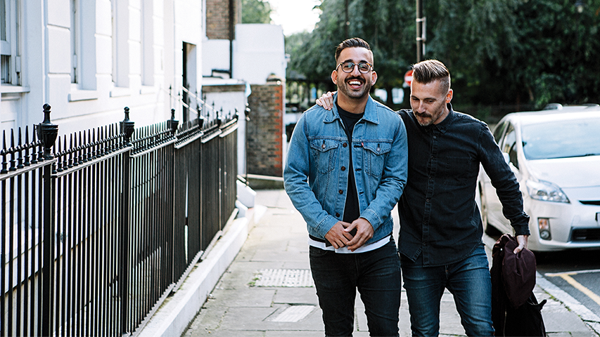 Two Mo Bros smiling while walking down the street