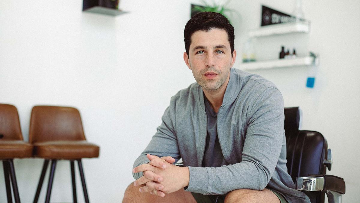 Actor Josh Peck sits in an LA barbershop