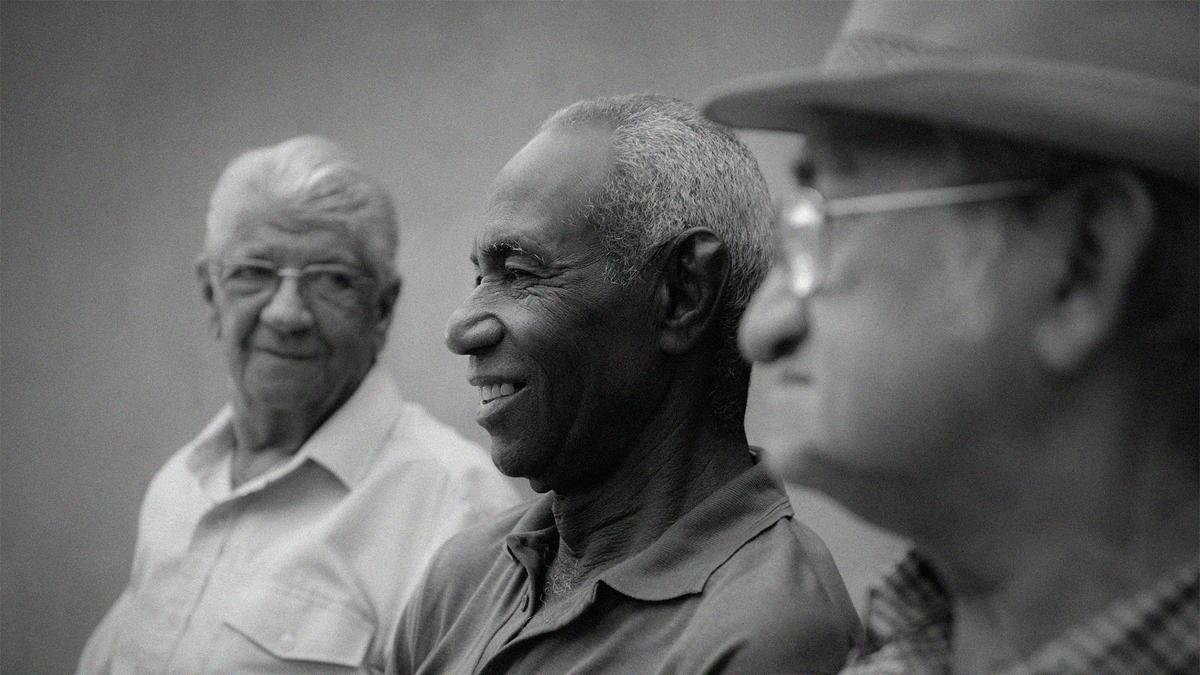 Three men sit together