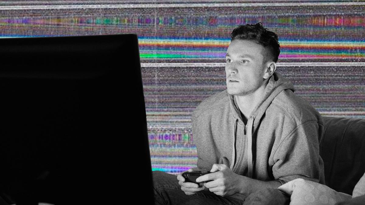 A young man playing video games with his eyes glued to the screen.