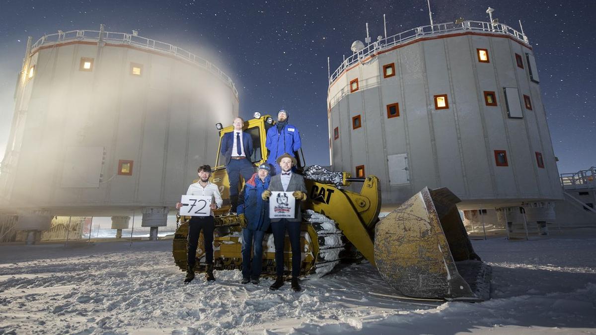Men at Concordia Antarctic Station holding Distinguished Gentleman's Ride signs.