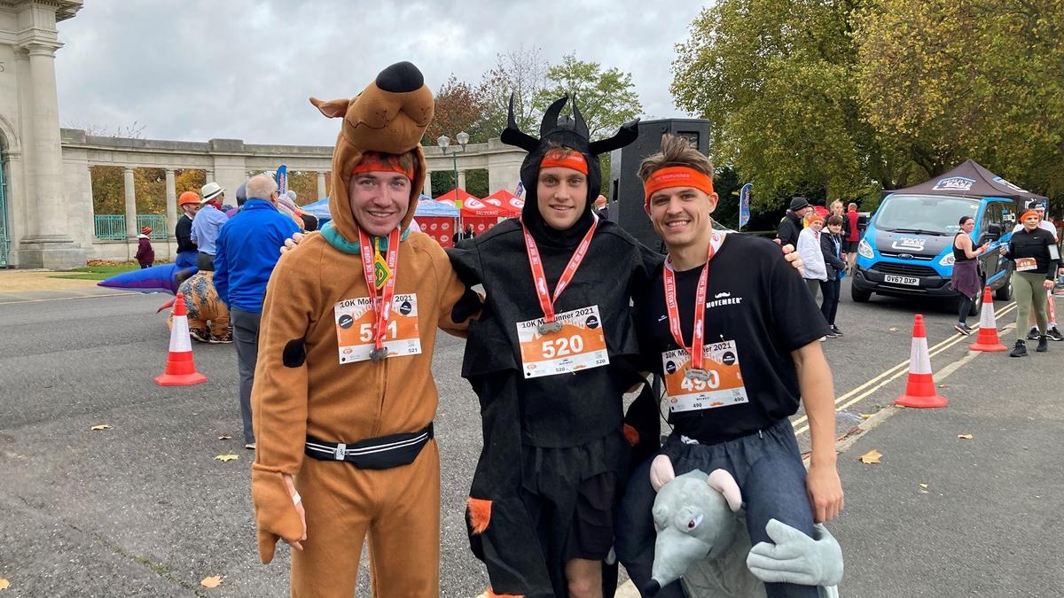 3 BDO young staff wearing fancy dress, posing for camera, before taking part in a run