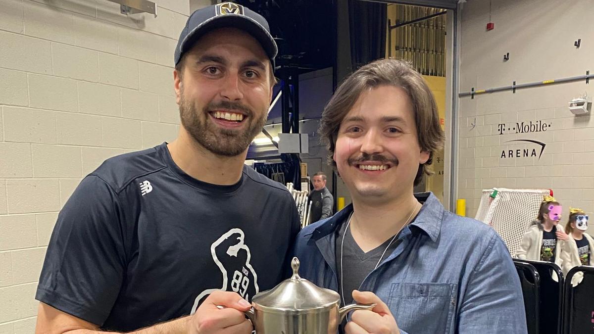 Two men holding a trophy