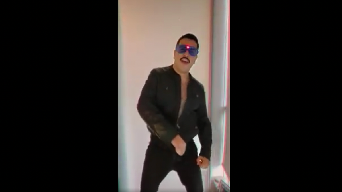 Man in sunglasses singing to camera