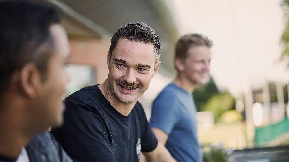Three men looking happy