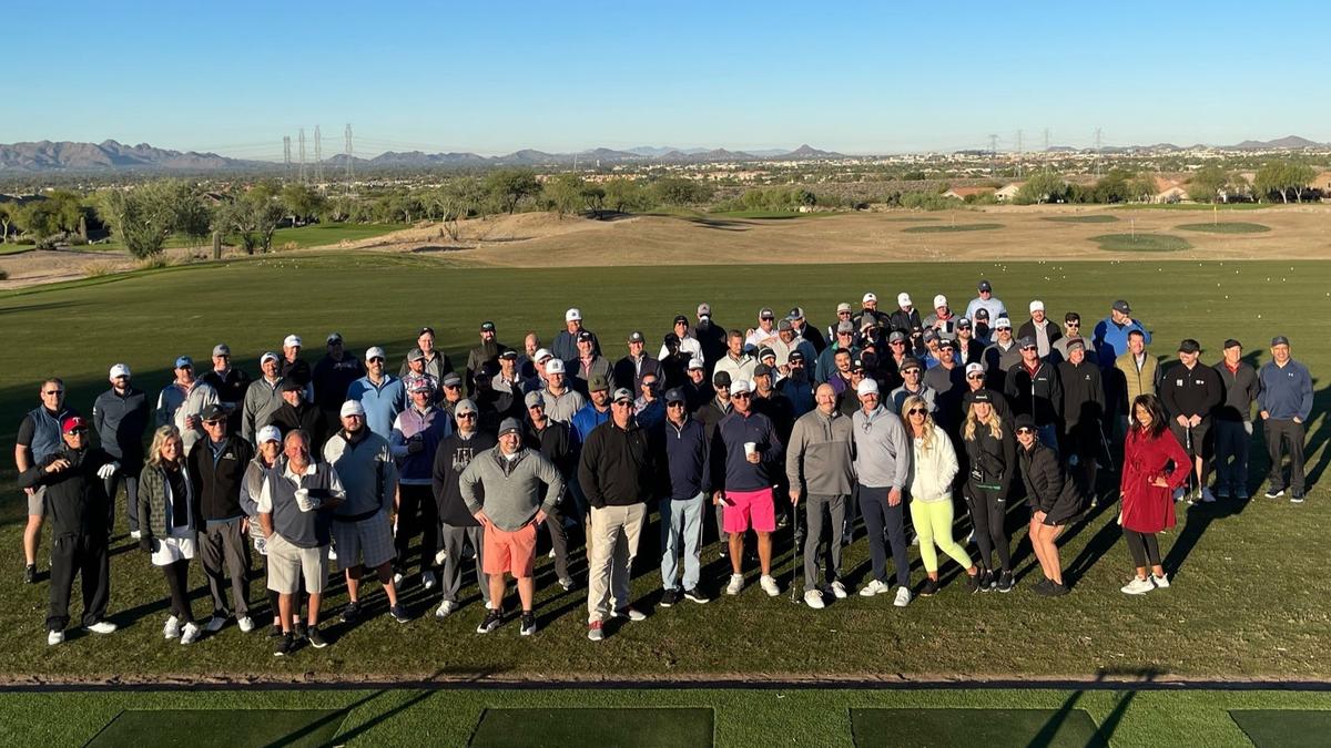 Over 80 golfers pose on a golf course in Arizona to help raise funds for Movember