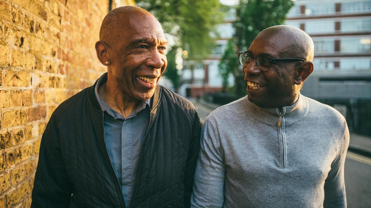 A photo of Mo Bros Bill and Herbie chatting and smiling.