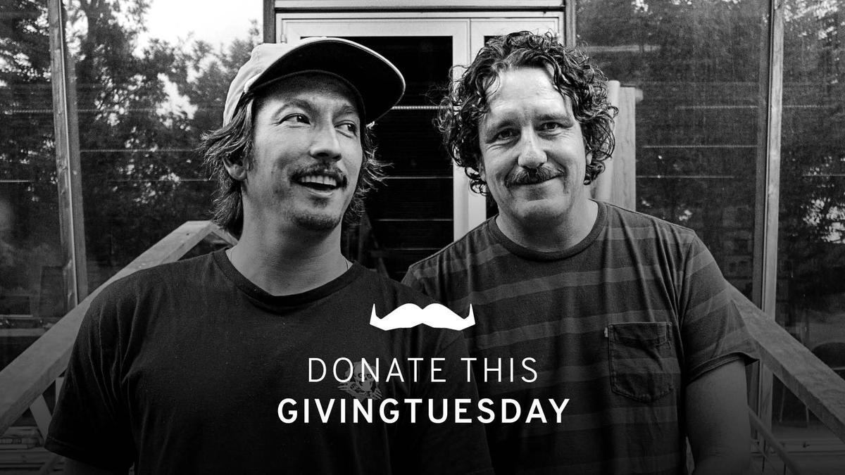 Photo of two men smiling to camera.